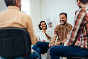group of people in outpatient treatment programs laugh