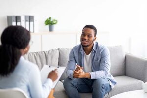 man talks with therapist about outpatient programs for addiction